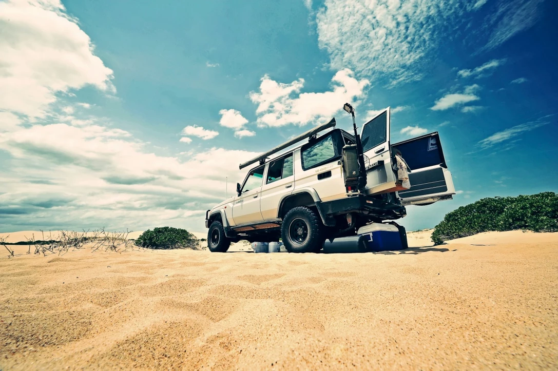 a white SUV on the beach