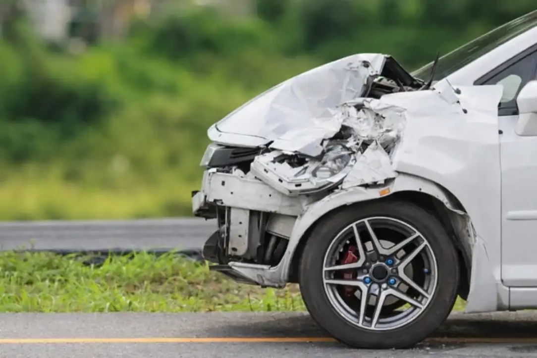 damaged car front showing collision impact during a test drive accident