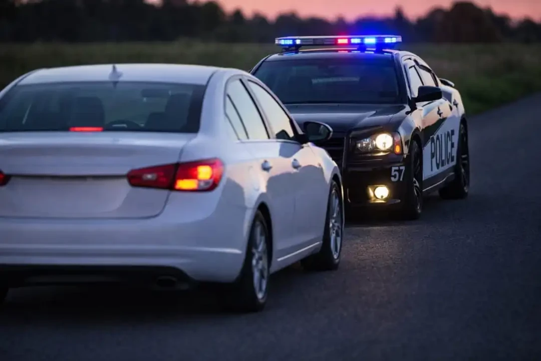 police officer pulling over a car for a possible registration issue
